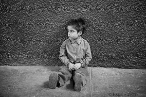 Boy leaning against wall b&w.jpg